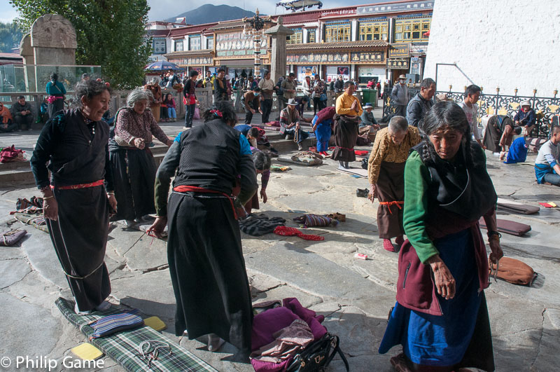 Worshippers prostrate themselves at the Jokhang Temple, Lhasa