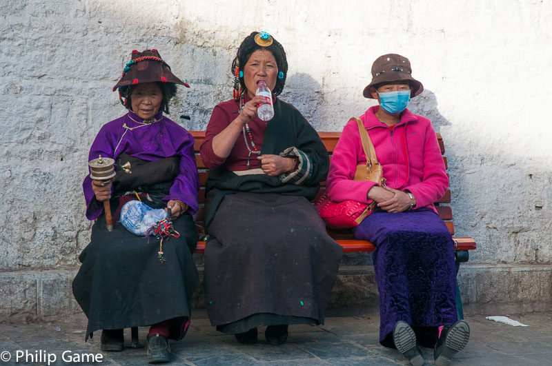 Pilgrims resting below the Potala Palace, Tibet