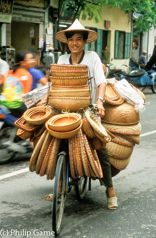 Vietnam: Heavily laden Hanoi cyclist