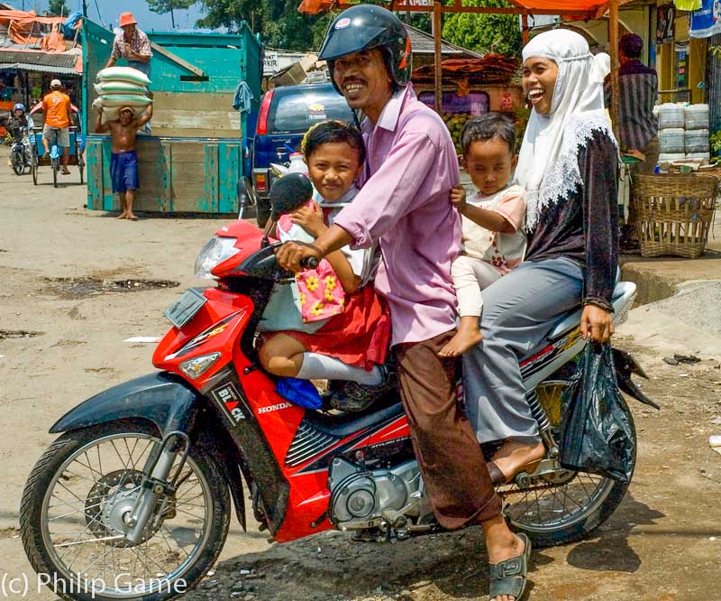 Indonesia: Family aboard a motorcycle, East Java