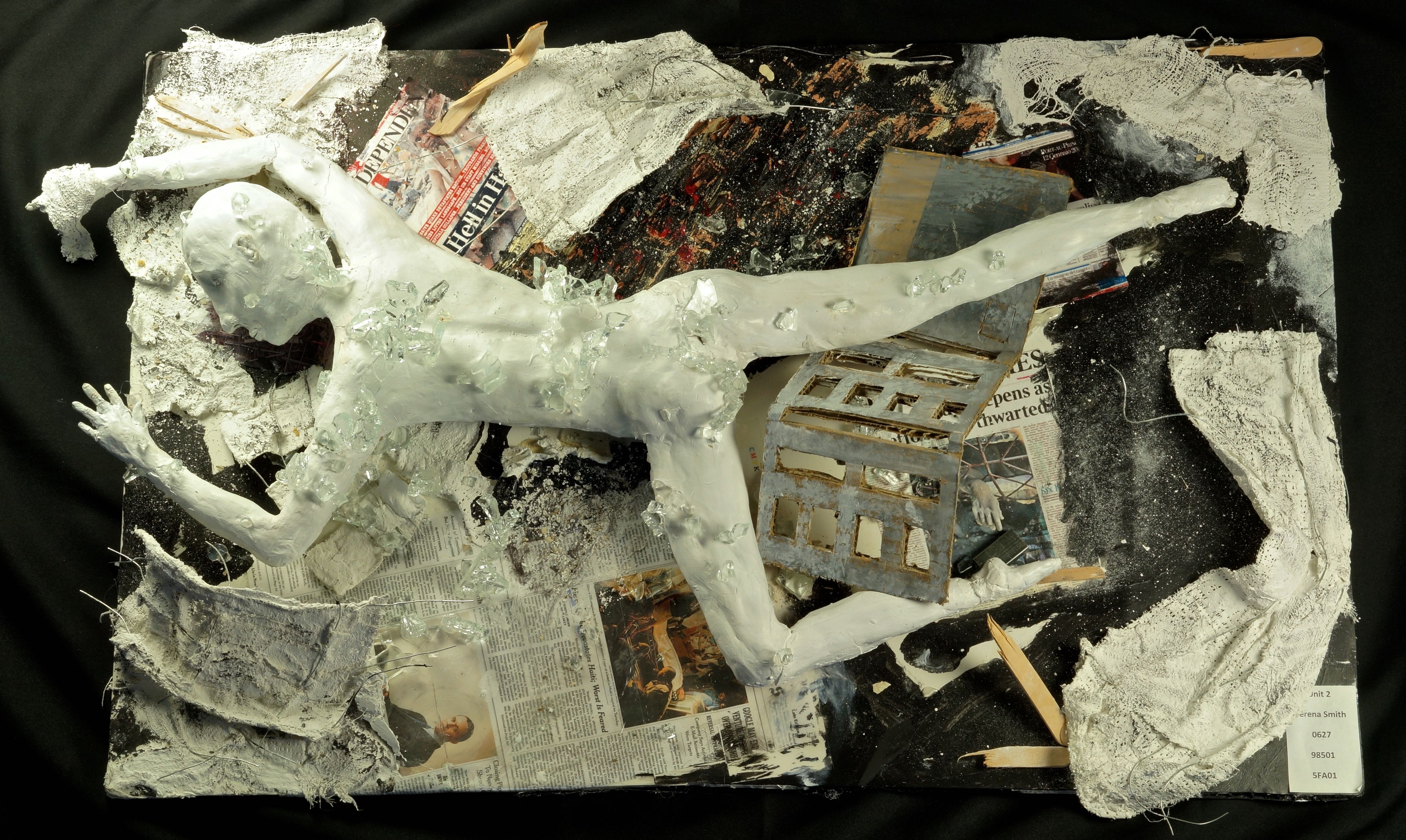 The fall. Clay, glass, fabric, newspaper, board. 615 x 374 mm.
