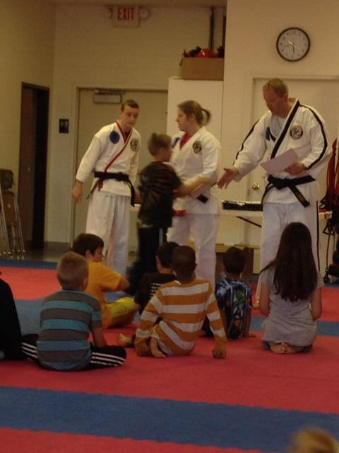 receiving his orange belt