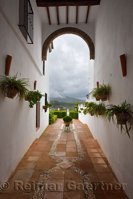Hallway to garden patio and rain clouds at Mondragon Palace Ronda museum Spain
