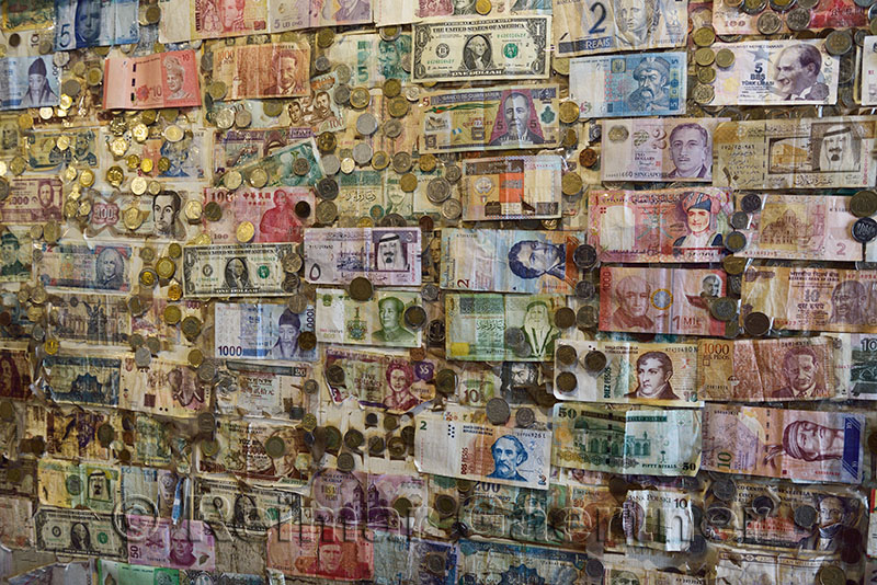 International currencies posted on a shop wall in Alhambra Granada