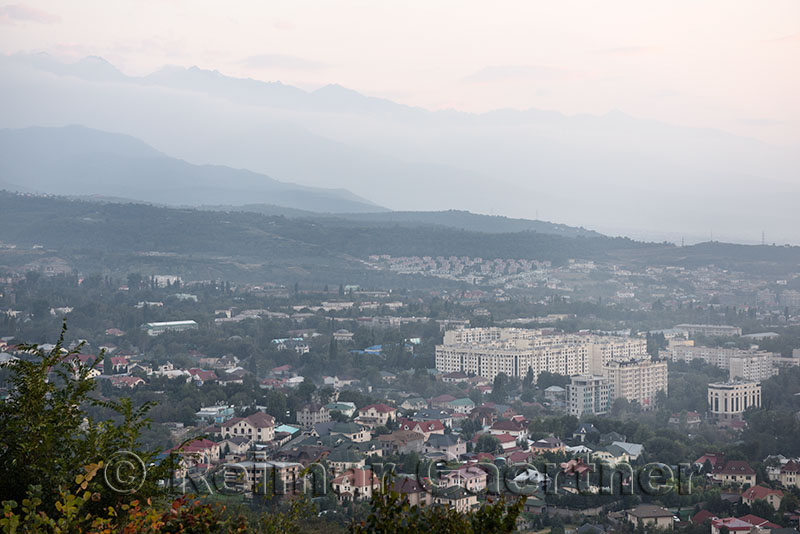 View of Almaty Gorny Gigant District and Zailiski Alatau mountains at dusk from Kok Tobe mountain