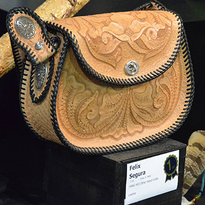 In display: a winning, carved leather purse!