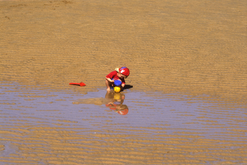 Child Playing on the Sand       