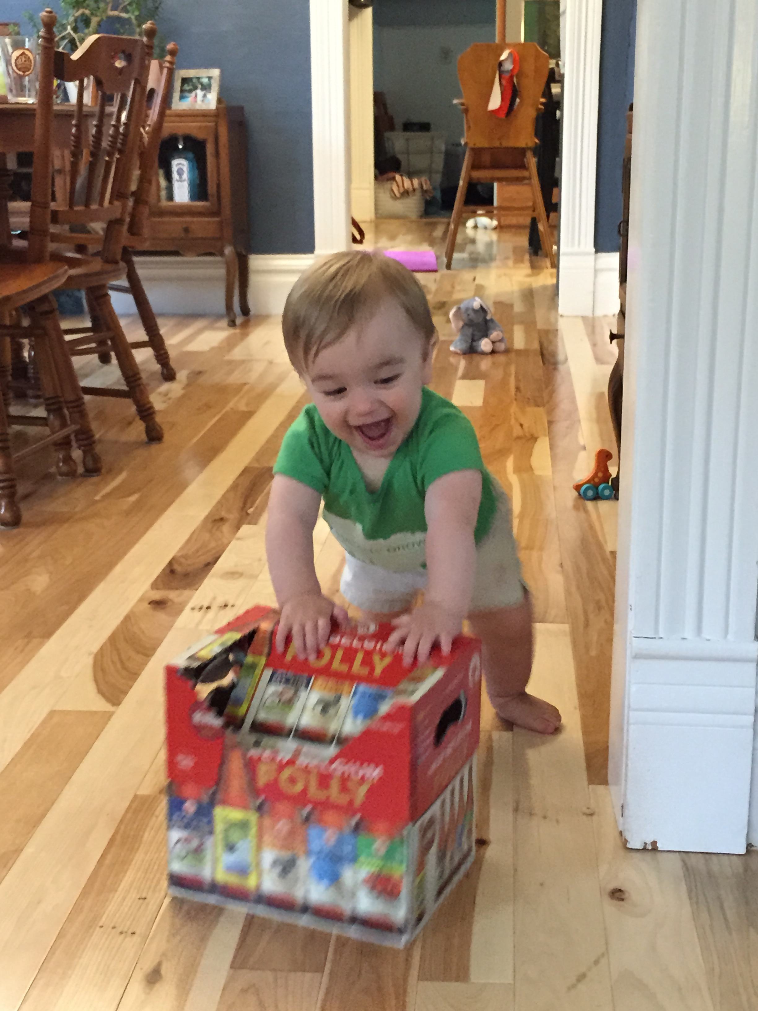 Practicing walking with Mom & Dads beer case.