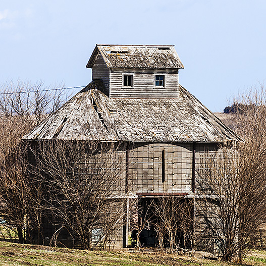 Looks like this might need a new roof and a little paint to put it back into its prime but with the new technology it still won't be used.
An image may be purchased at http://edward-peterson.artistwebsites.com/featured/iowa-concrete-corncrib-edward-peterson.html