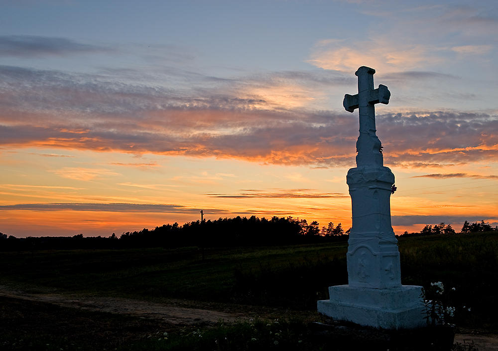 Cross Against The Colorful Sky