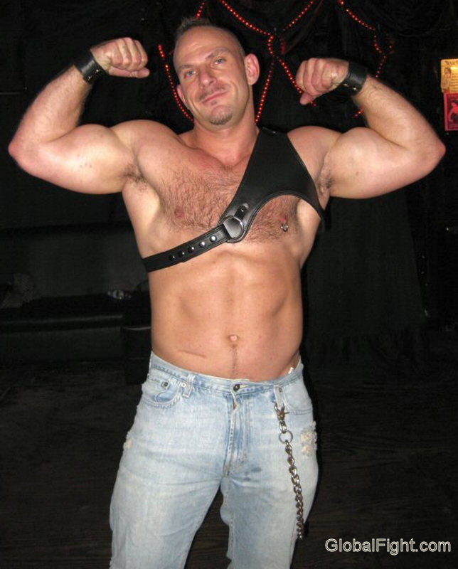 leather daddie flexing biceps.jpg