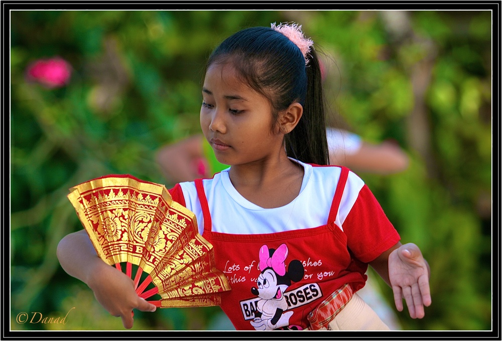 A Young Girl during a Legong Dance Lesson Open air.