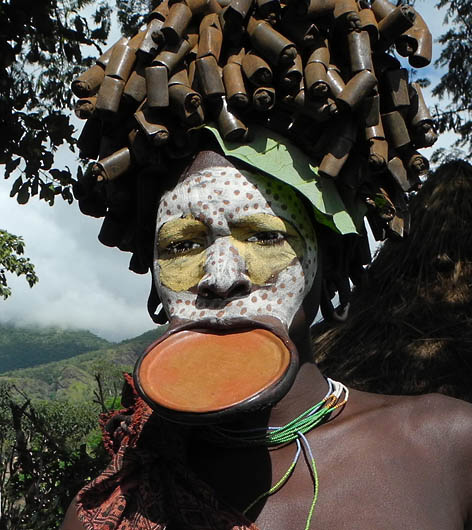 Surma woman with lip plate and decoration;  south-western Ethiopia.