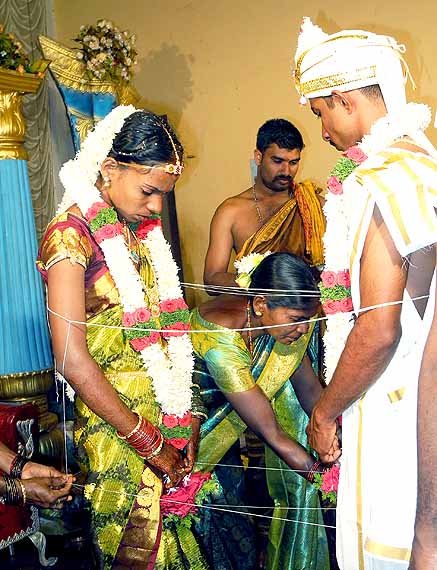 Forever united. The couple is tied together by threads; Wedding ceremony in Karnataka, India