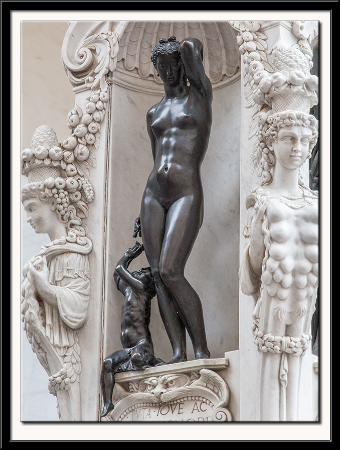 A face of the plinth on which stands Perseus holding the Head of Medusa. 