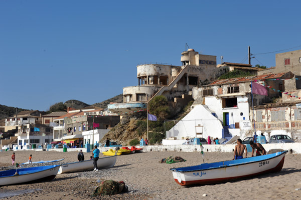 Small fishing boats pulled up on the town beach, Bouzedjar