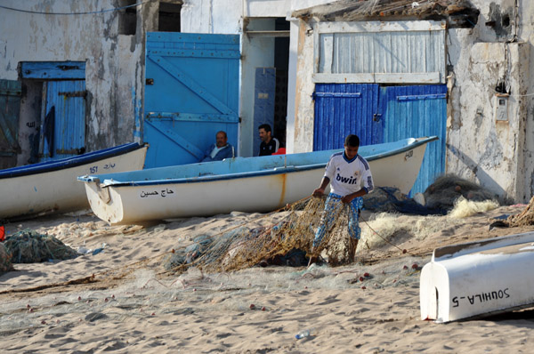 Fisherman preparing his nets on Bouzedjar's beach