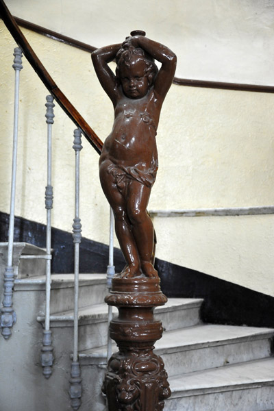 A peak in the door - an old French bannister in the shape of Cupid