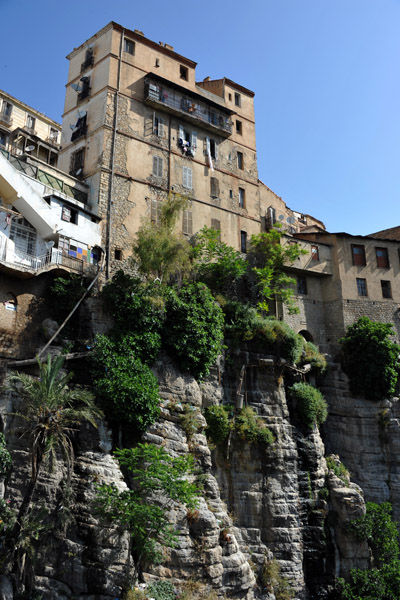 Tall building in the old city rises directly from the cliff