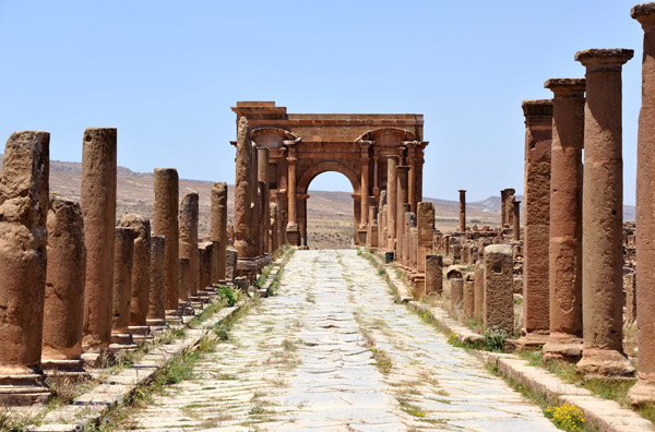 The Decumanus Maximus with its chariot-rutted stones heading west to Trajan's Arch