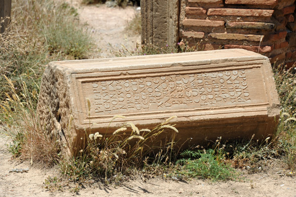 Fallen inscription stone, Grand South Baths - Timgad