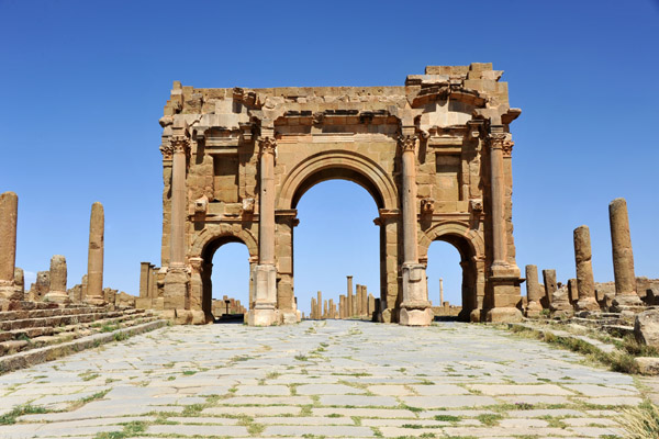 Ruts ground out by the wheels of chariots are visible leading to the central portal of Trajan's Arch