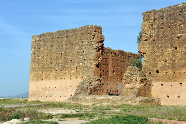 Breach in the wall of the Mosque of Mansourah to the left of the minaret