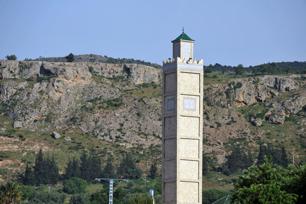 Nearby, a modern minaret with the ridge of the Plateau Lalla Setti