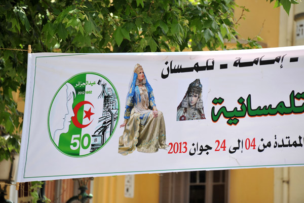 Banner in Tlemcen with the 50th Anniversary of Independence logo and a woman in traditional dress