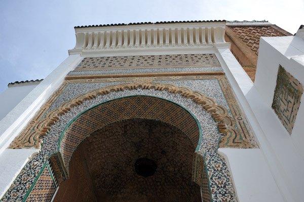Zellige tiles cover the keyhole arch forming the main entrance to the Mosque of Sidi Boumediene