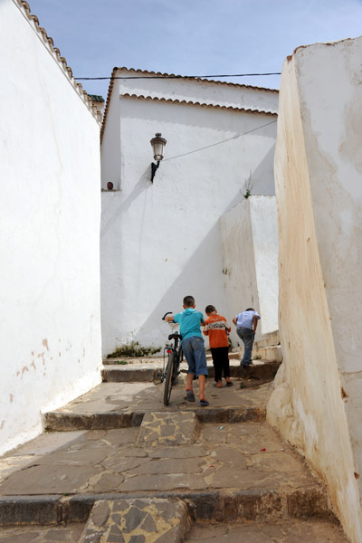 Village kids pushing a bike up the steep alleys of Sidi Boumediene