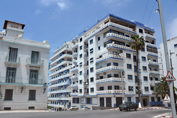 Blue and white apartment with wrap around balconies, Oran