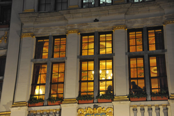 Lights through the upper windows of La Rose Blanche, Grand Place
