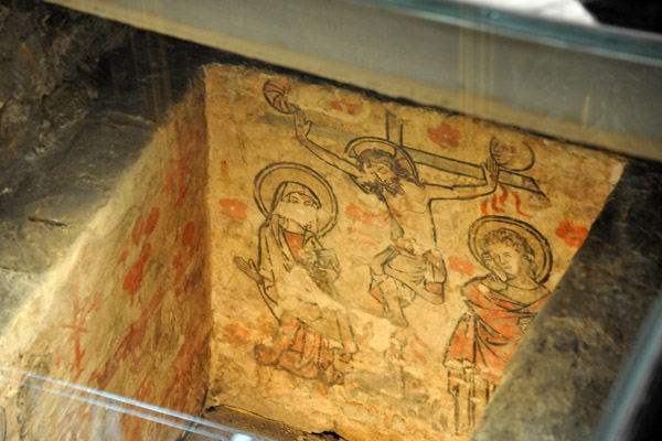 Glass floor in front of the Altar of Calvary showing medieval tomb frescos 
