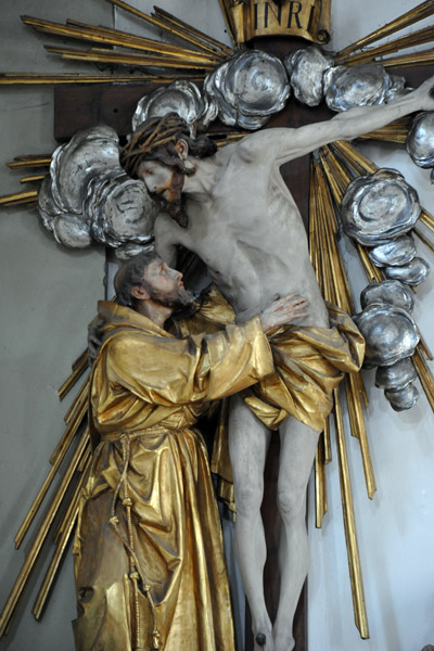 St. Francis putting his arms around Christ on the Cross