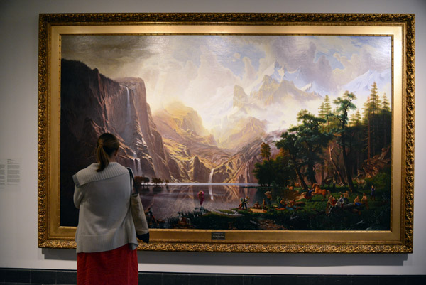 Visitor admiring Kent Monkman's Trappers of Men