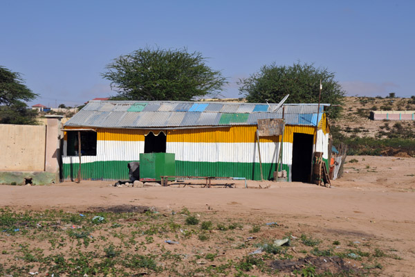 Large tin shack painted in the colours of the Indian flag
