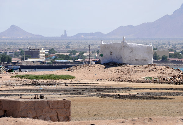 Small whitewashed building on the sand spit forming Berbera harbor