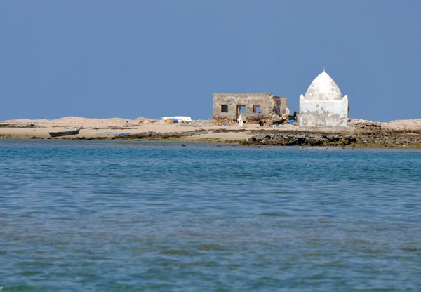 Islamic tomb and a wrecked stone house on the sand spit across from the harbour 