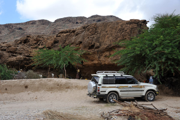 We pass another Land Cruiser parked in front of a cave 