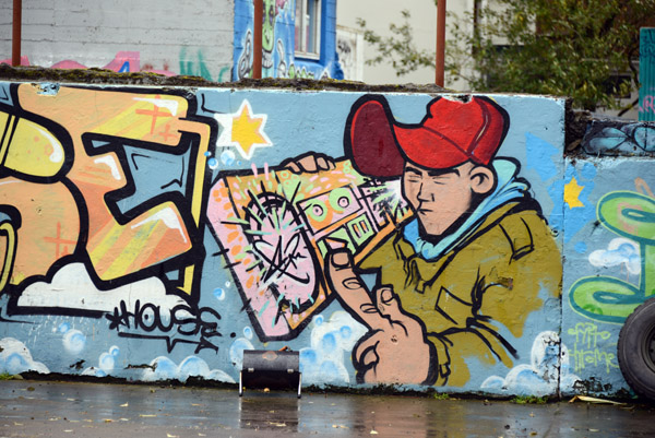Graffiti wall art of a boy with a juke box, Reykjavk