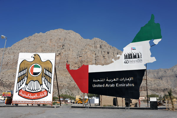 Large signs with the UAE national emblem and map, Al Jeer
