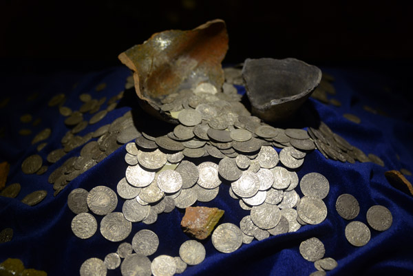 Broken ceramic pot with a spilled hoard of silver coins