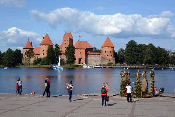Tourists on the promenade along Lake Galvė with Trakai Island Castle