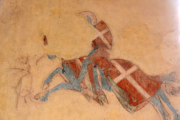 Remains of a wall mural of a mounted saint