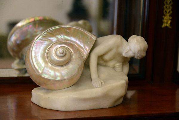 Marble statuette of a naked woman emerging from a natural seashell