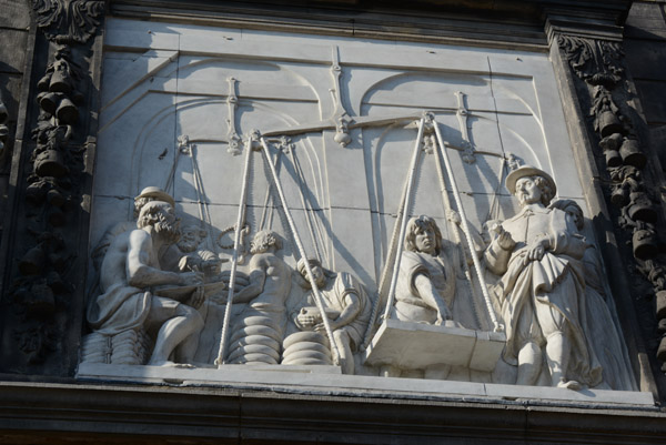 Sculpture relief weighing wheels of cheese on the faade of the Goudse Waag