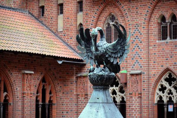 Pelican on the roof of the well  in the courtyard of the High Castle, Malbork