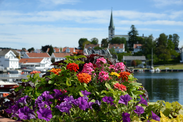 Flowers along the harbor with the Lillesand kirke