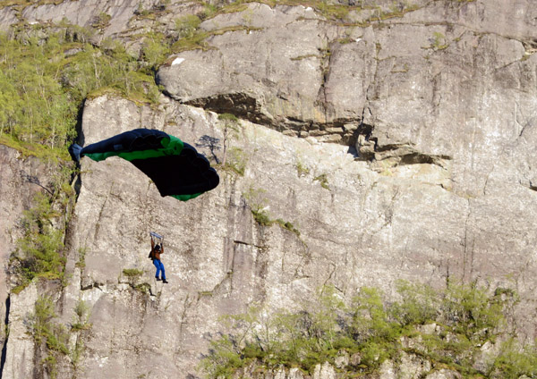 Paraglider coming into land on the valley floor, Lysebotn